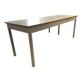 Vintage industrial table with a Formica top and wooden accents.