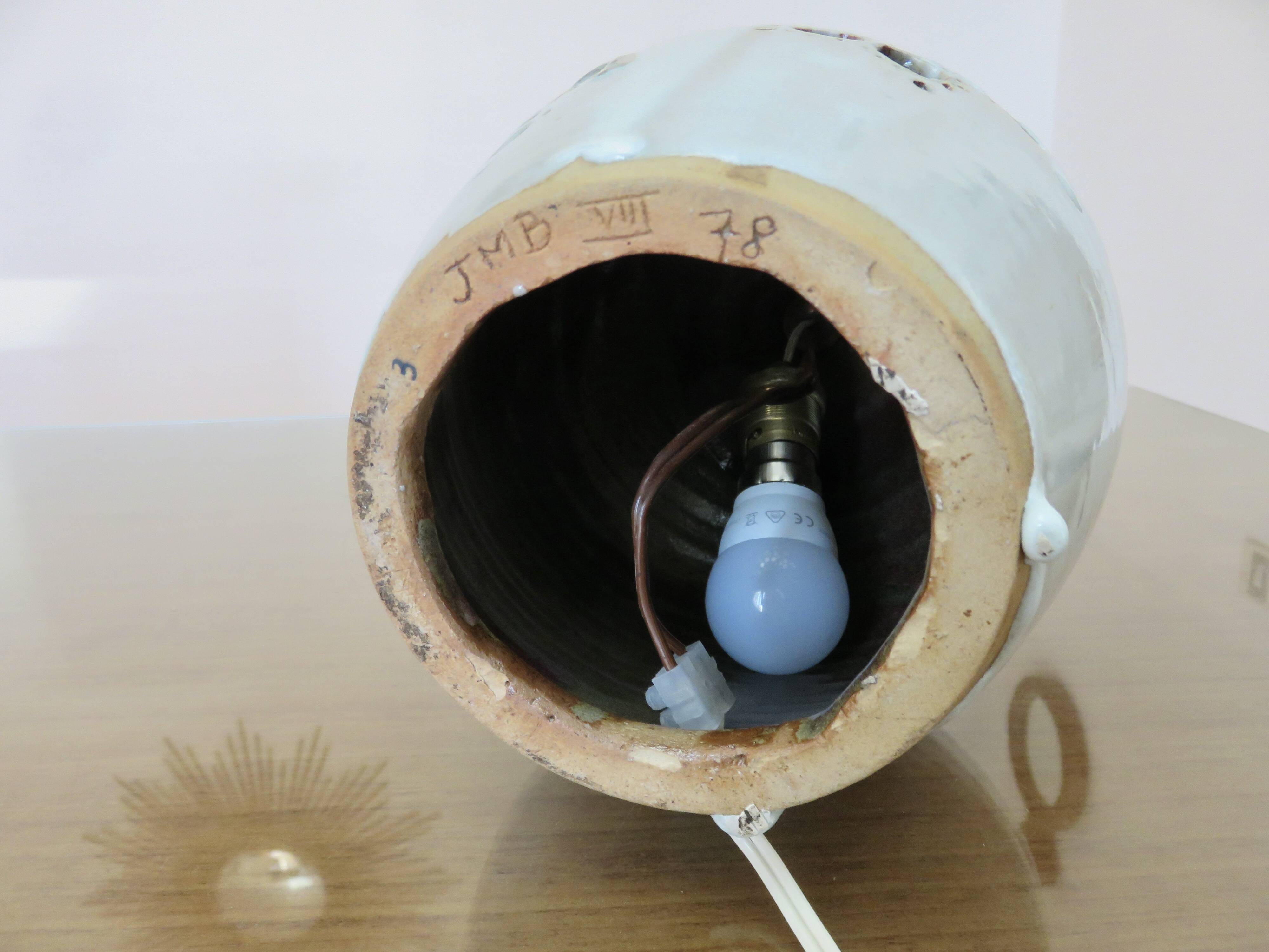 Ceramic lamp with double lighting and openwork design.