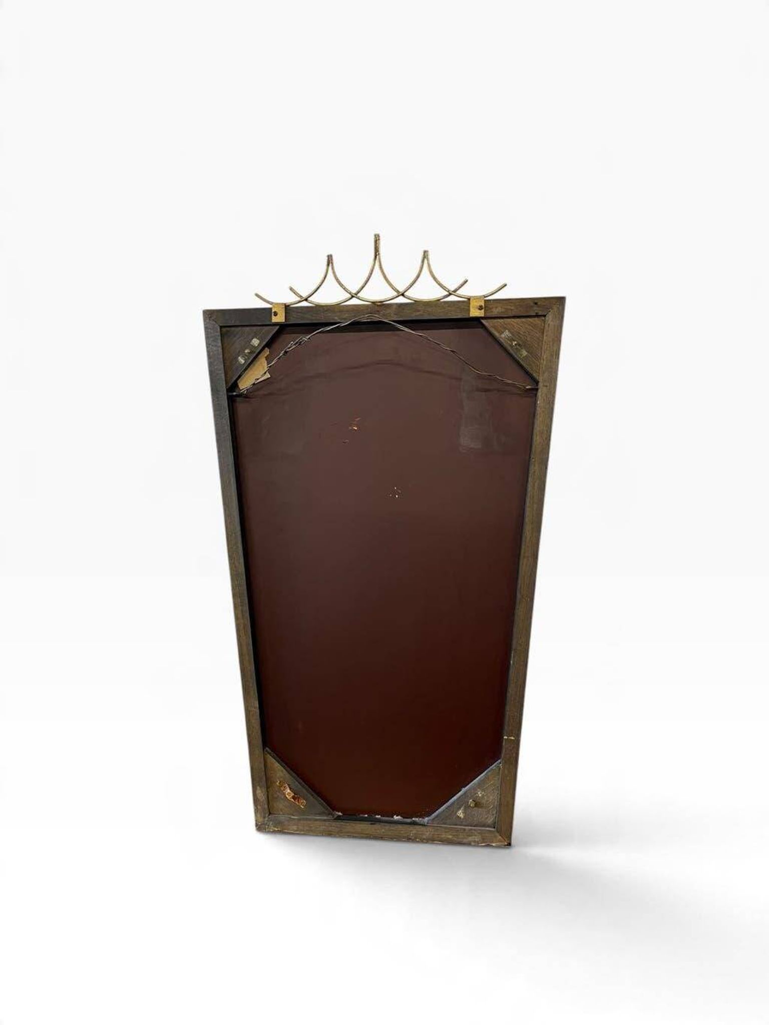 Elegant black wall mirror in vintage style with brass accents.
