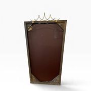 Elegant black wall mirror in vintage style with brass accents.