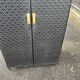Contemporary wardrobe in black faux leather with diamond pattern and gold handles.