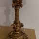 Golden baroque-style table lamp with a shade adorned with pendants.