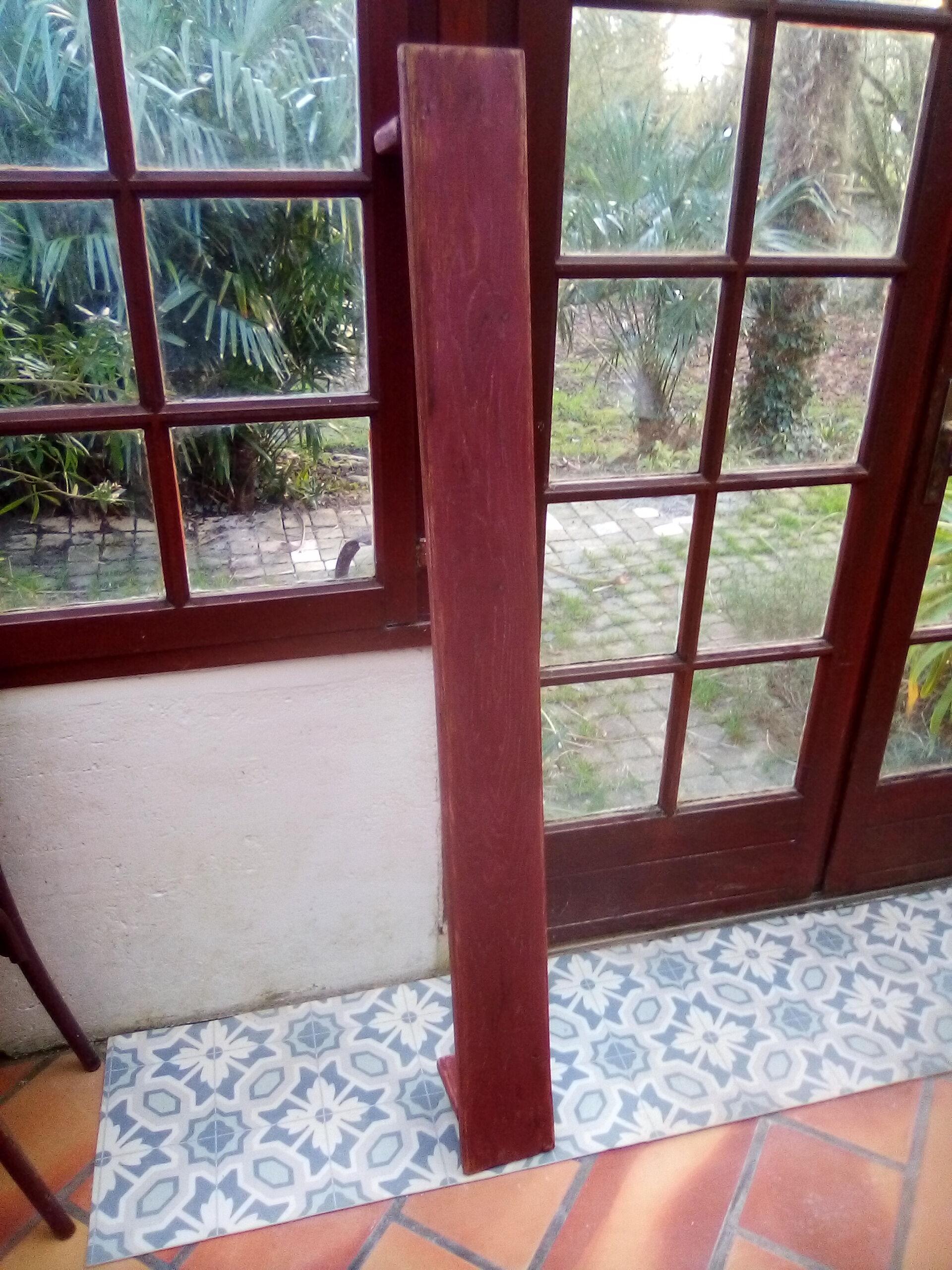 Low bench rests feet in patinated wood