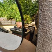 Vintage smoked bronze wall mirror, free form, 1970s – 70 x 55 cm