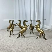 Hollywood Regency style coffee table, 6 patinated brass horses and glass top, 1970.