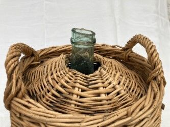 Demijohn type canister covered in wicker