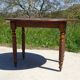 Walnut drop-leaf table with honey spoon legs.