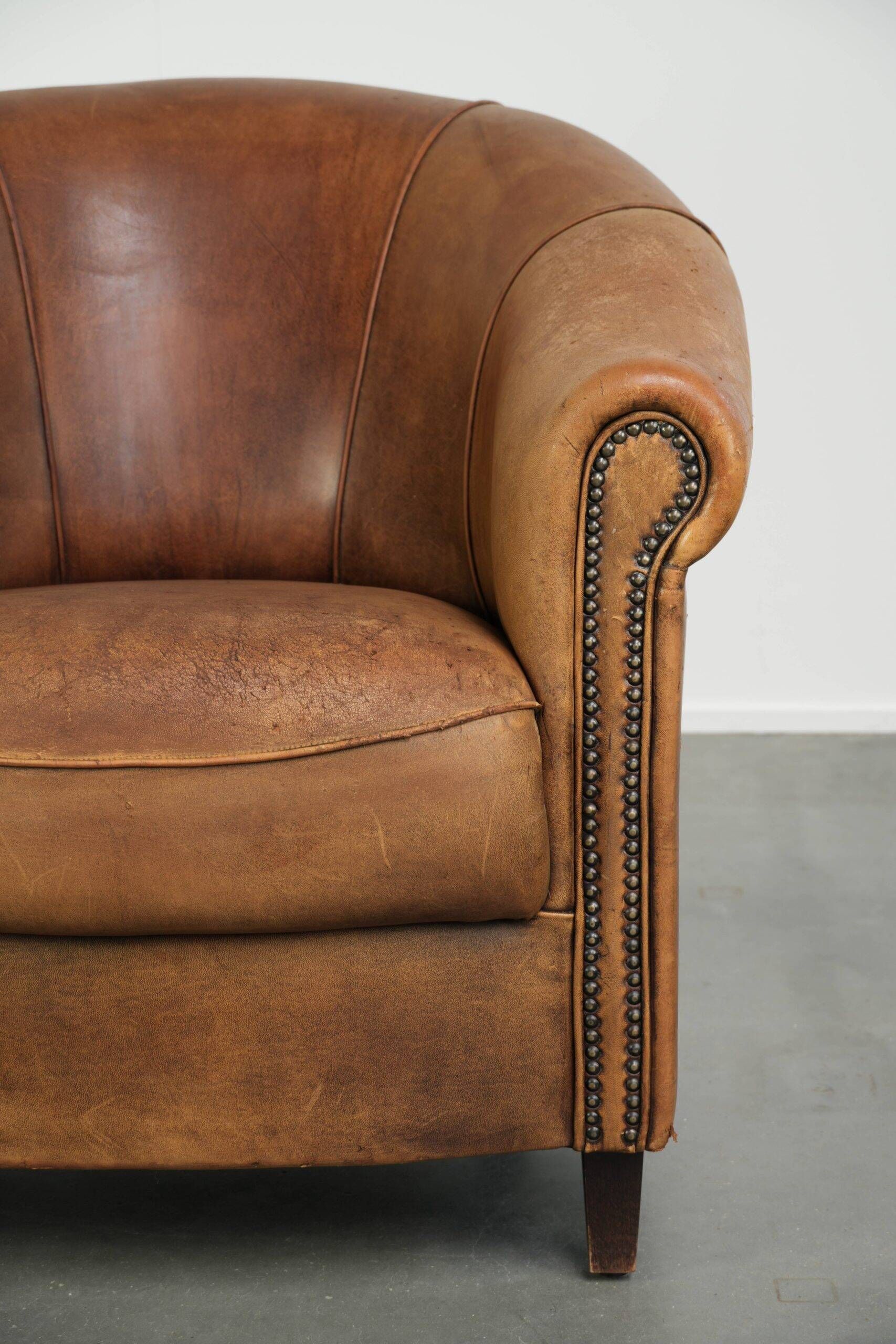Aged sheepskin clubchair with beautiful vintage patina and comfortable seat