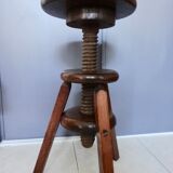 Old wooden stool has adjustable screw