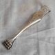 Antique silver-plated sugar tongs with lion's paws.