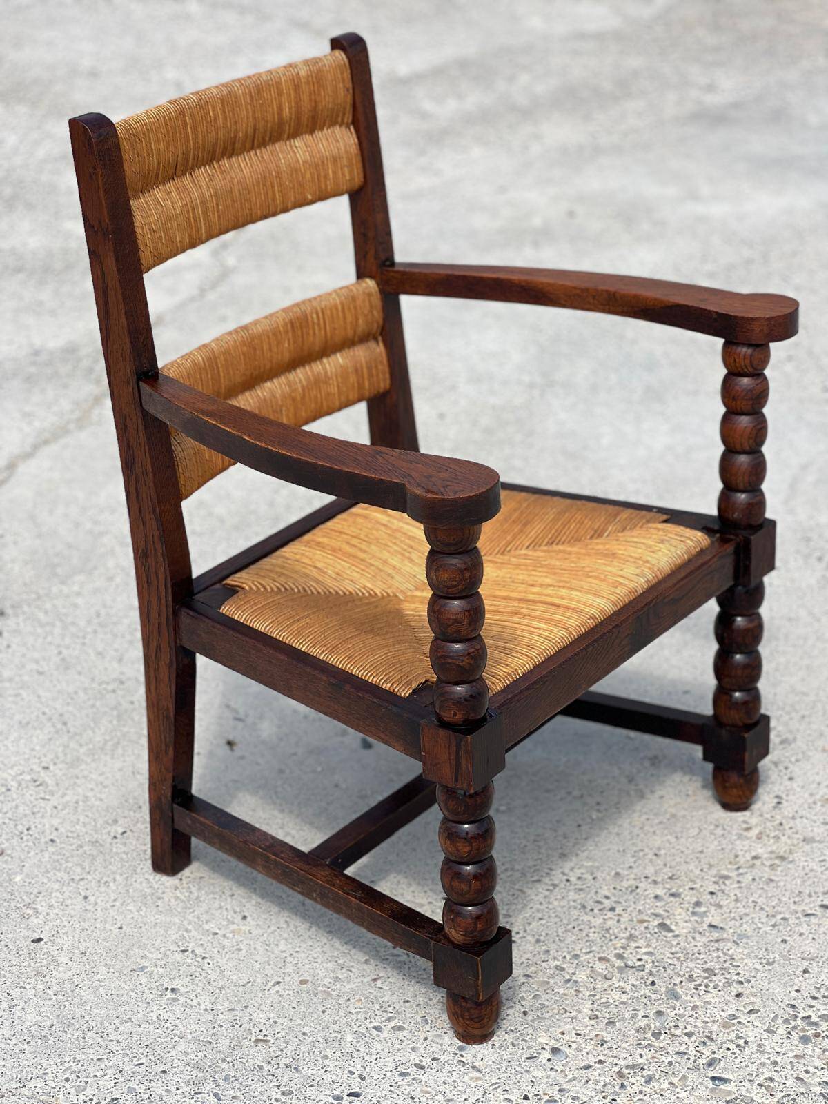 Armchair in stained oak and straw, French work from 1950.