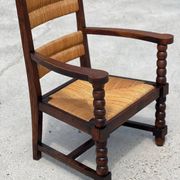Fauteuil en  chêne teinté et paille, travail français 1950