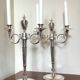 Pair of silver-plated metal candelabra decorated with hunting horns