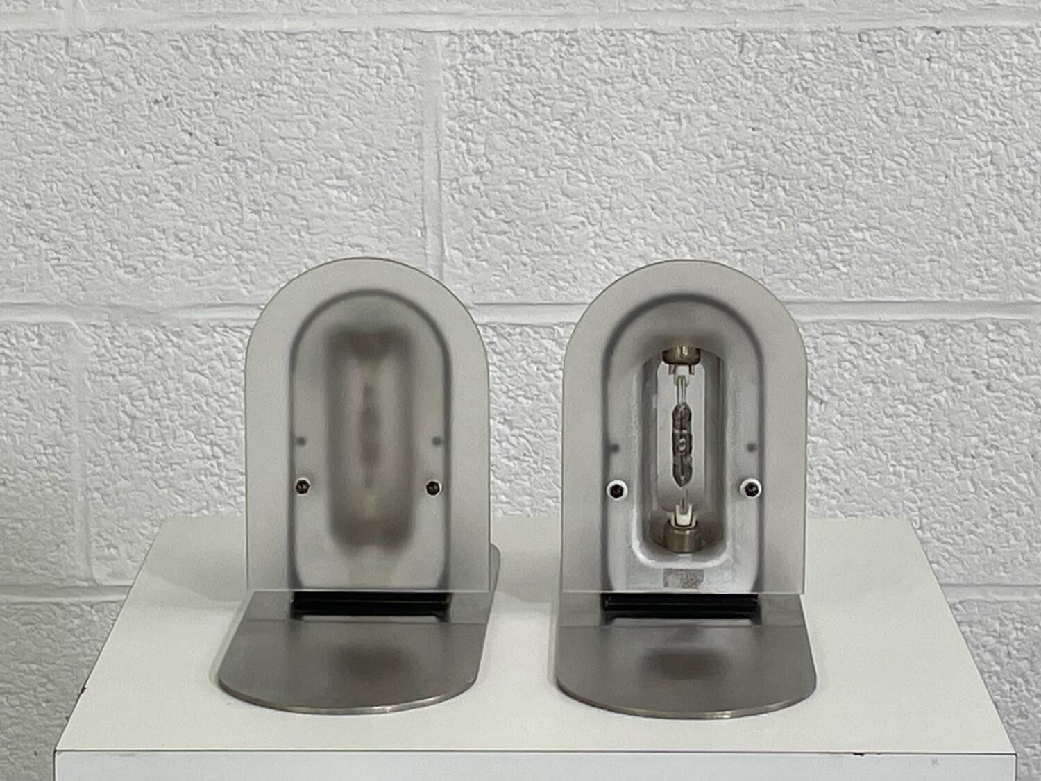 Pair of vintage stainless steel and glass wall lights
