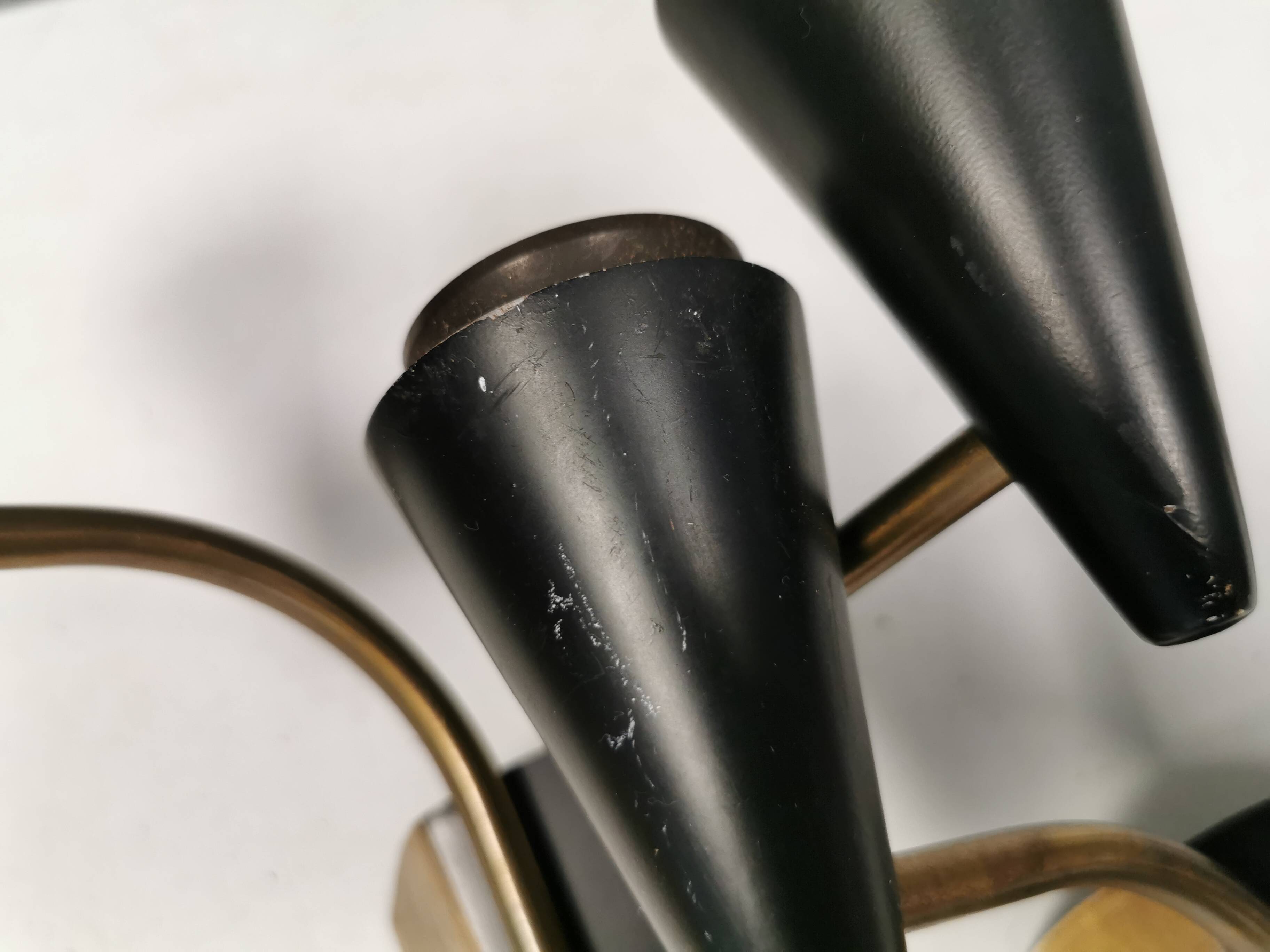 A set of wall lamps in black lacquered metal with brass details