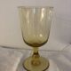 Yellow chalice vase, yellow glass vase on a pedestal.
