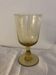 Yellow chalice vase, yellow glass vase on a pedestal.