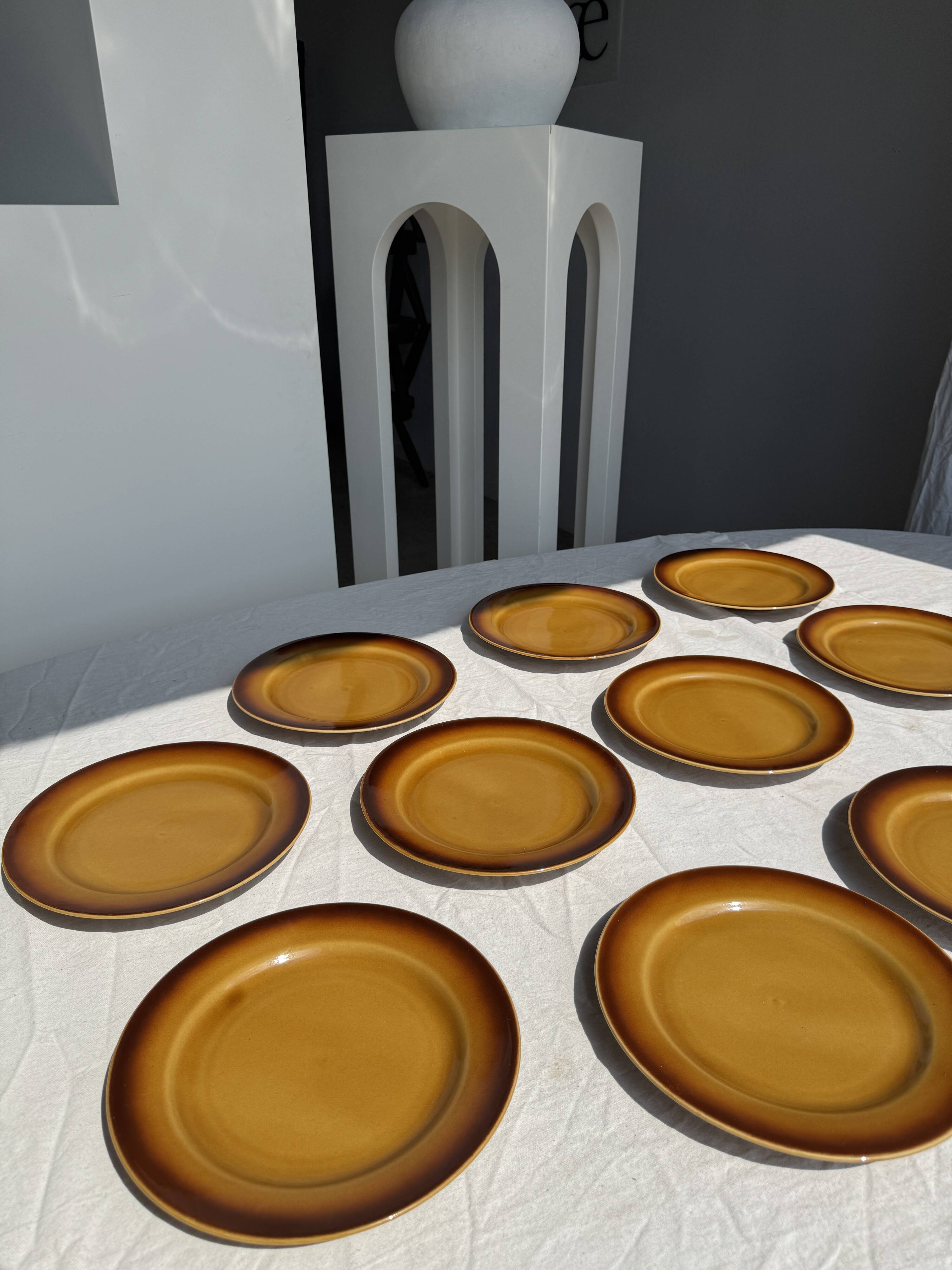 Set of 11 dark brown yellow stoneware plates D24