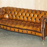 Vintage Chesterfield serpentine luxury sofa in restored leather