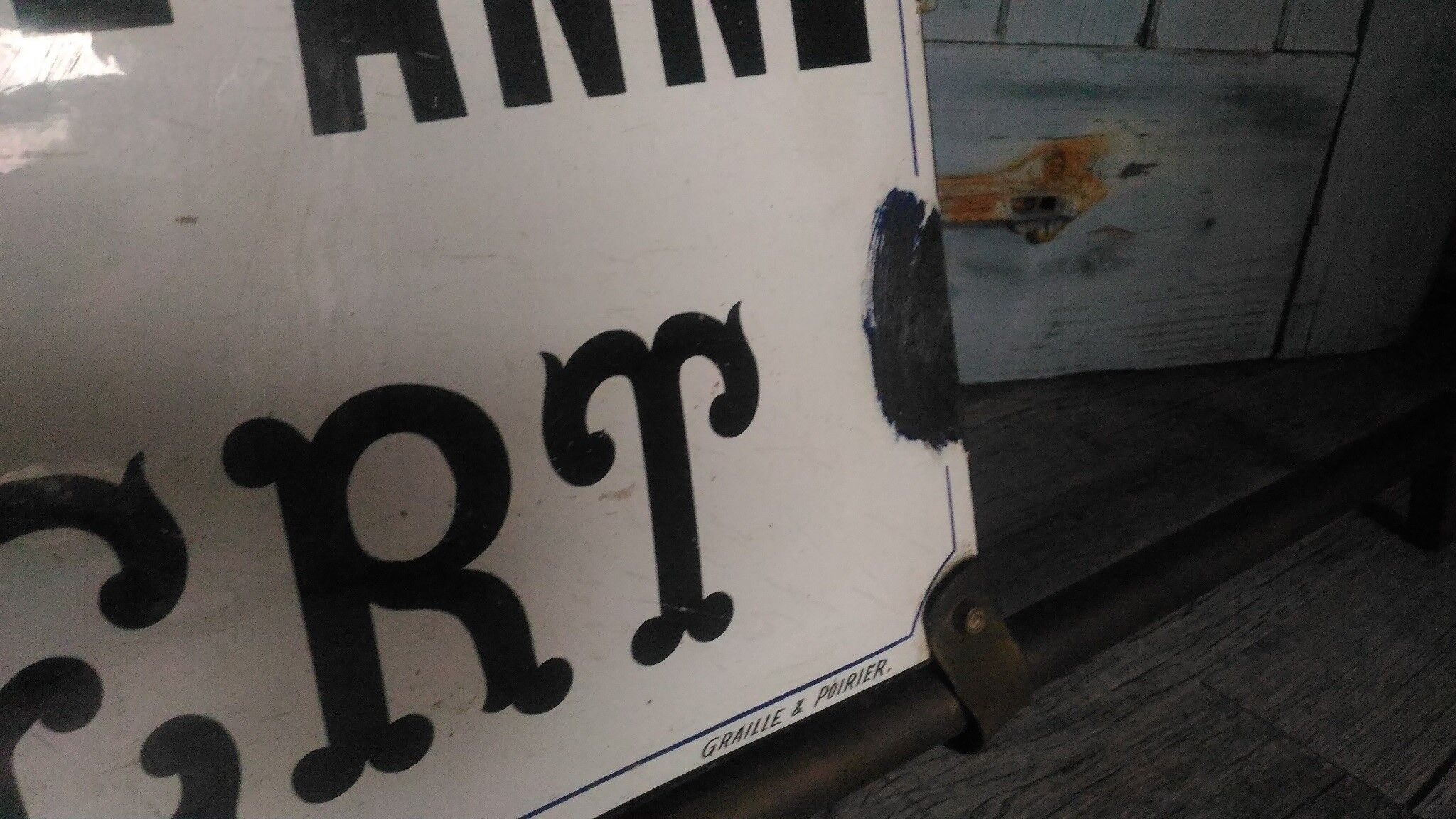 Photographer enamel sign