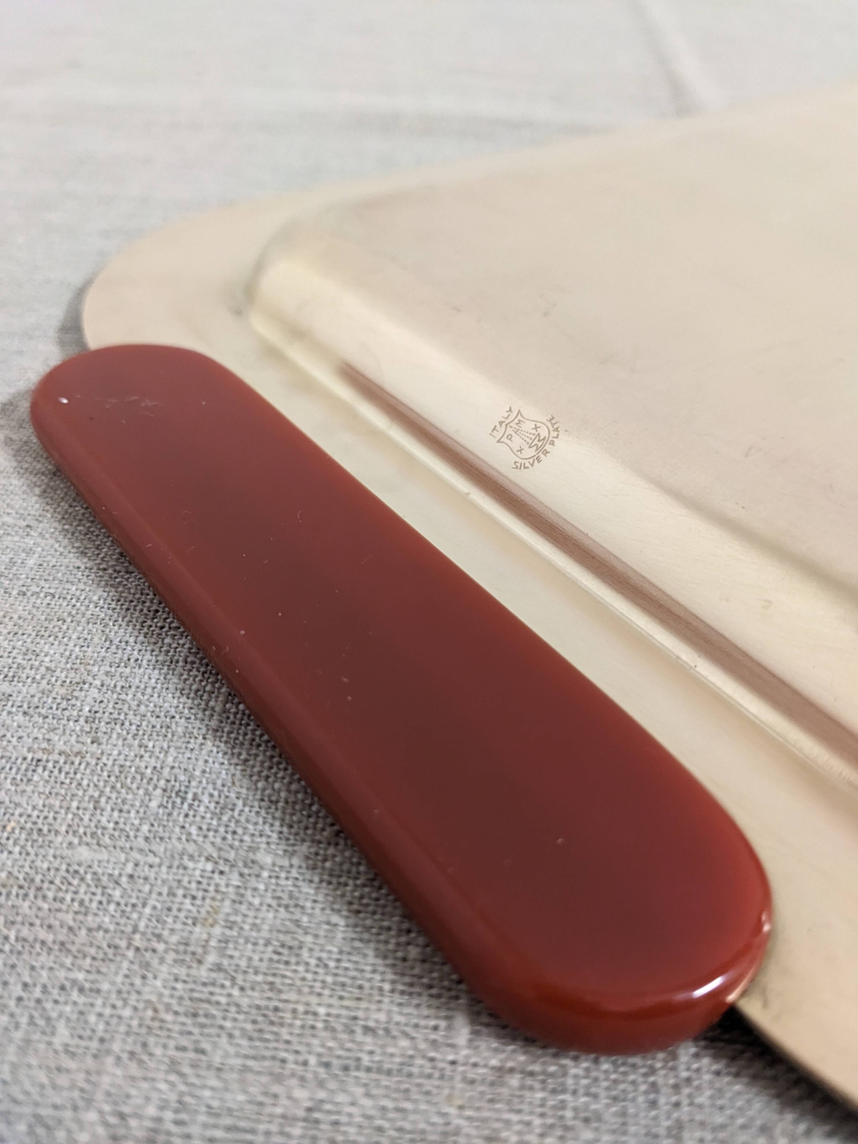 Plates and a brass and Bakelite cut by PM Italy, Italy around 1970.