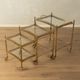 Set of 3 vintage Hollywood Regency nesting tables with brass frame and glass tops (1960s)