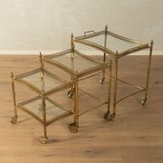 Set of 3 vintage Hollywood Regency nesting tables with brass frame and glass tops (1960s)