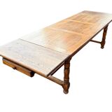 Large farmhouse table made of solid wood.