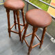 pair of vintage wooden and leather bar stools