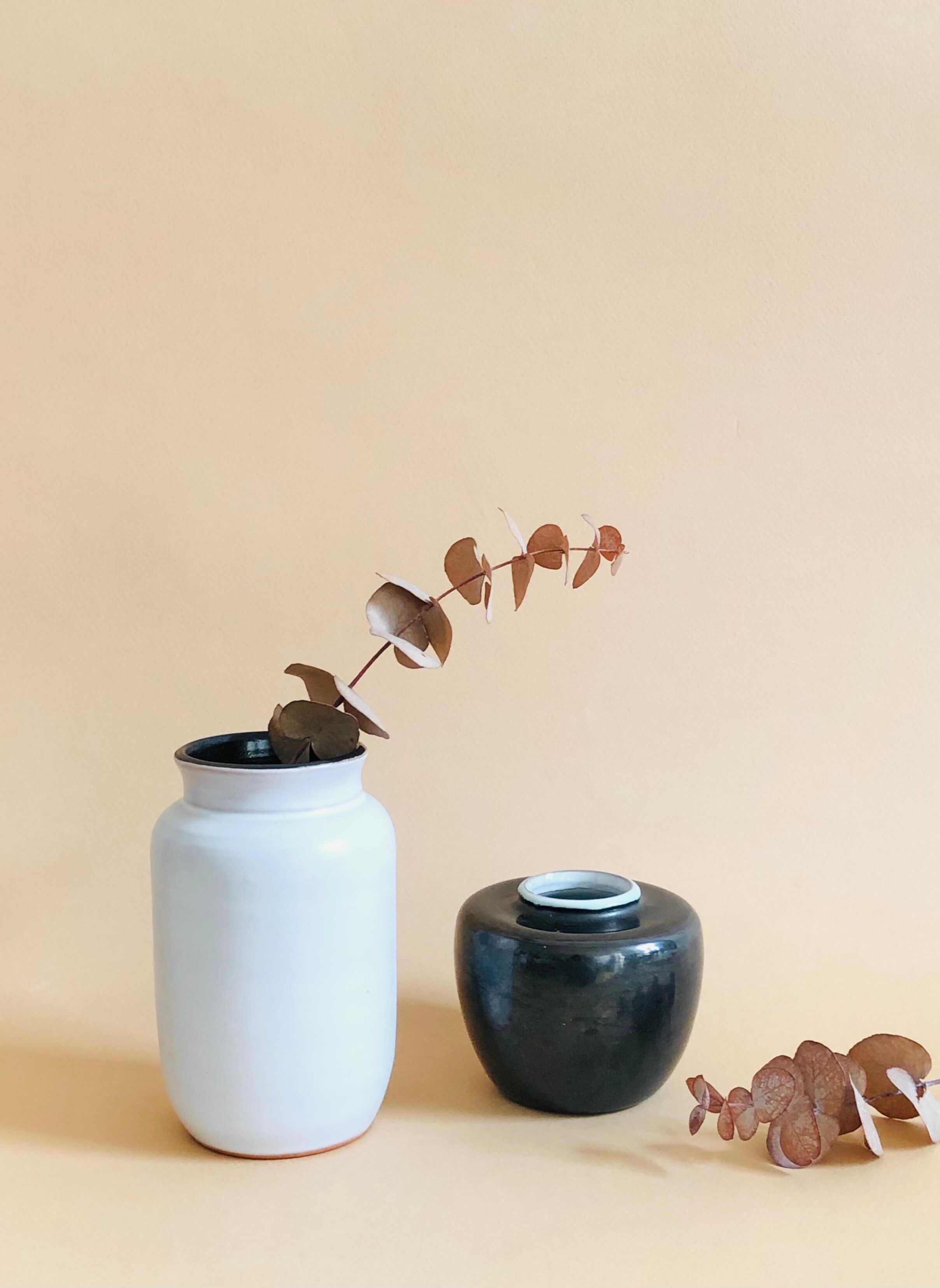 Duo of small black and white ceramic vases