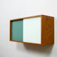 A vintage mid-century wall hung oak cabinet, green & white glass doors