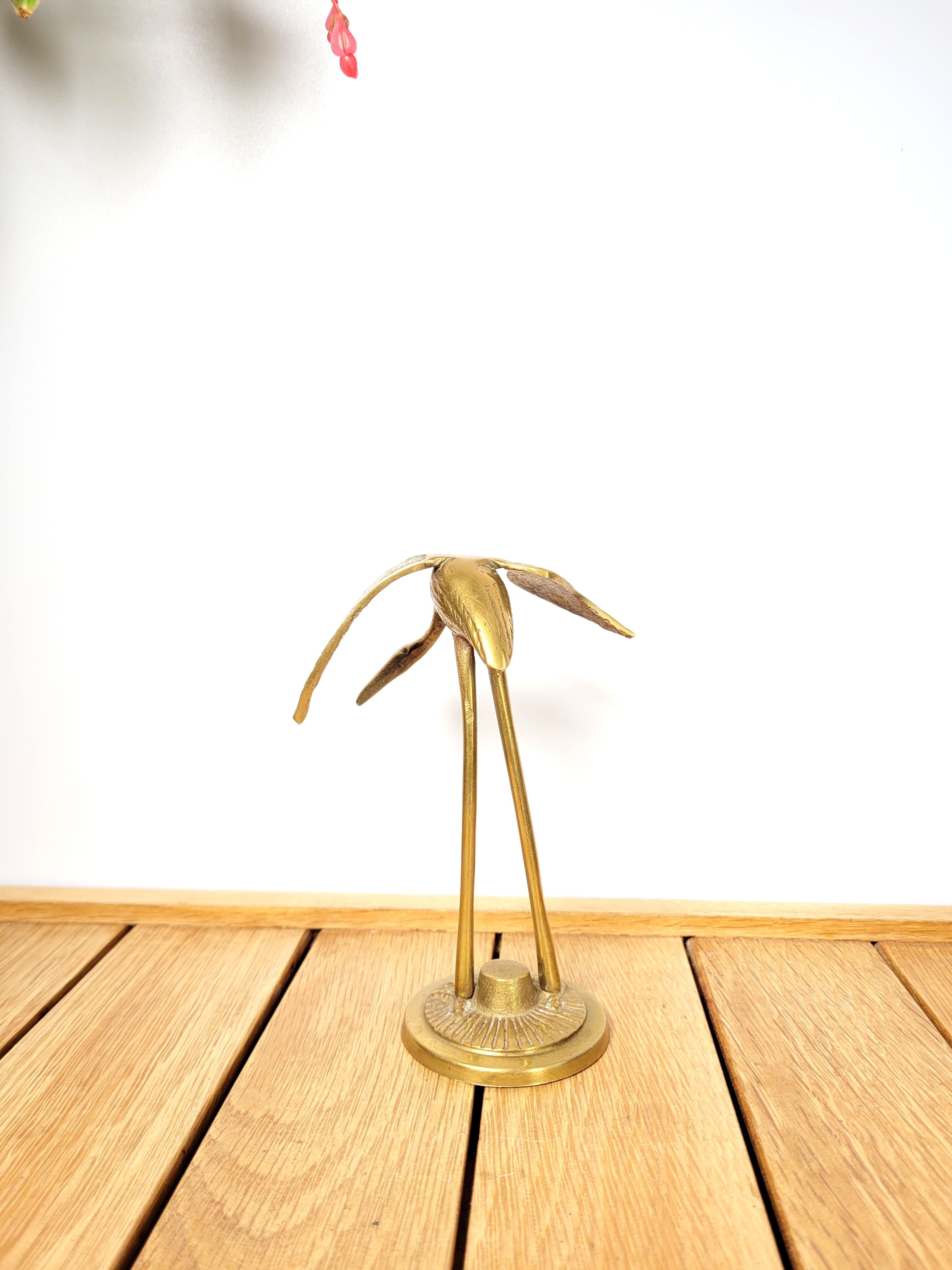 Brass heron head down