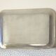 Vintage stainless steel serving platter with marine decor and golden handles.