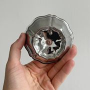 Set of 9 low bowls in shiny stainless steel.