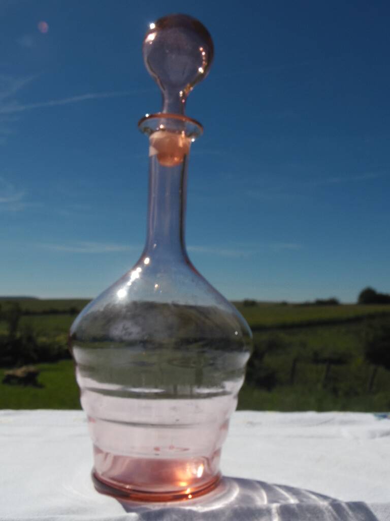 Pink transparent glass carafe with bubble cap