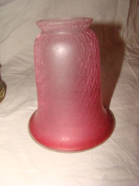 bronze bedside lamp with a pink cracked glass shade