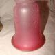 bronze bedside lamp with a pink cracked glass shade