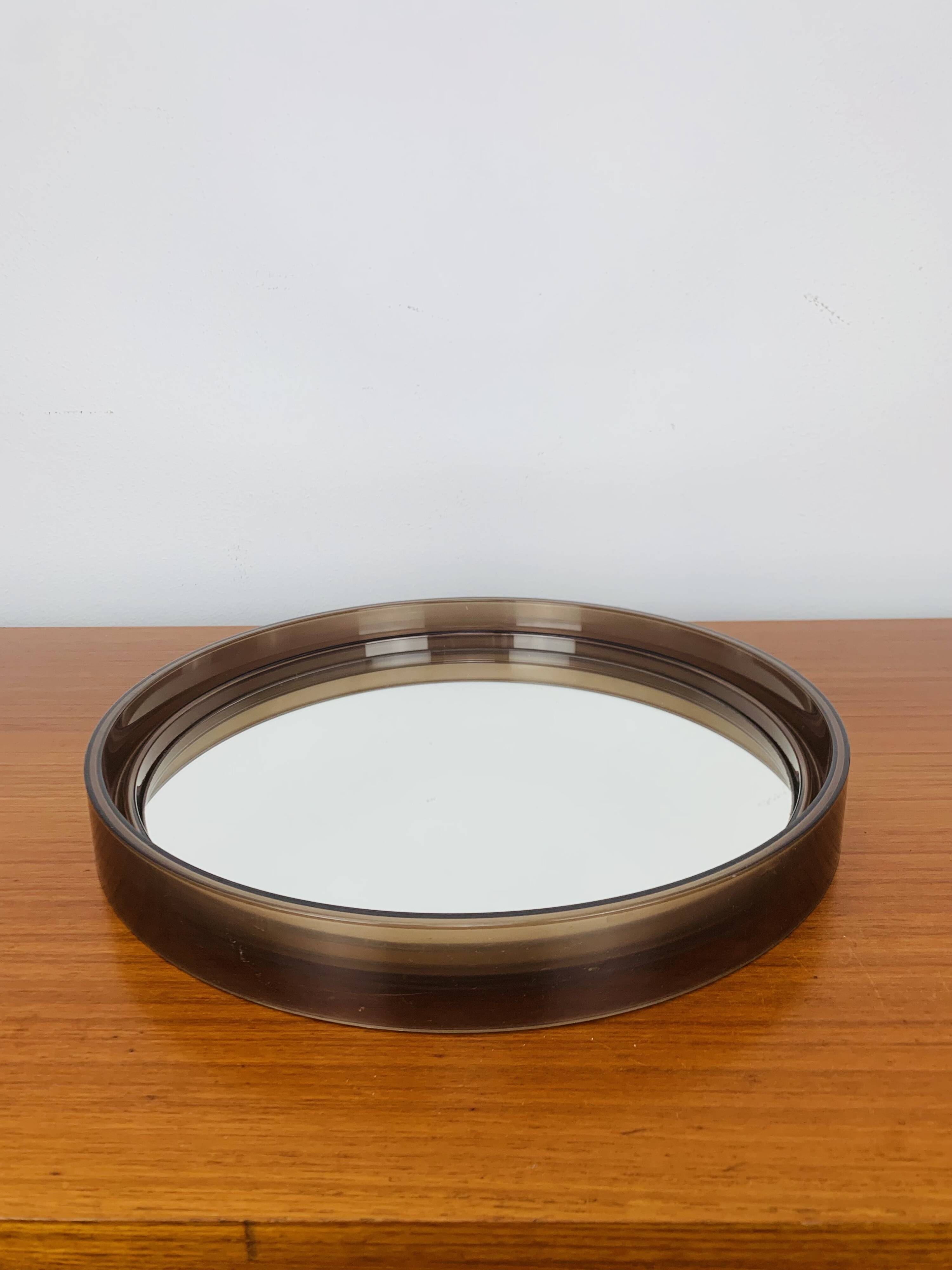 Round mirror with amber rim from the 70s, vintage