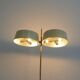 Brass and lacquered metal floor lamp with a wooden magazine shelf.