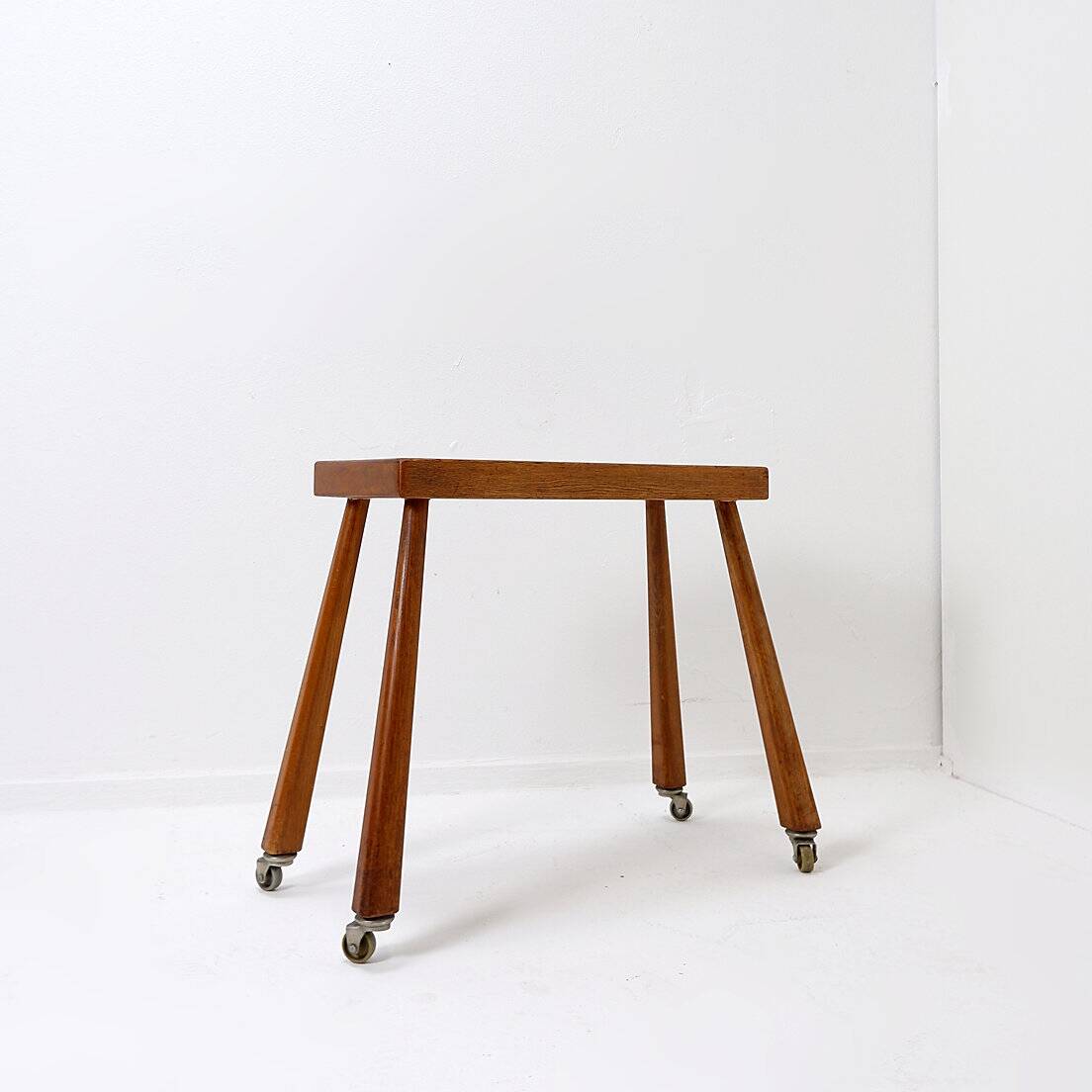 Vintage solid wood side table on casters