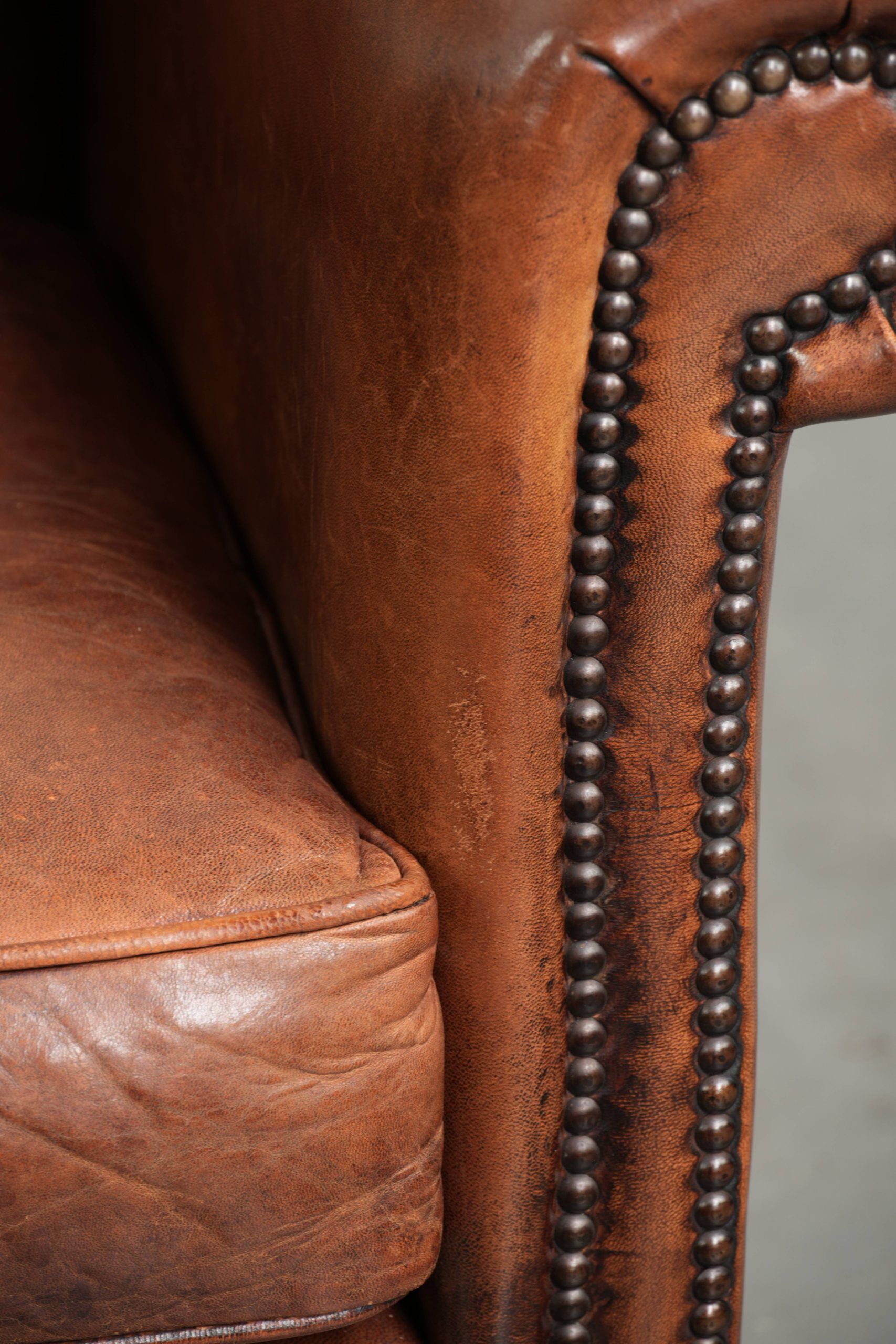 Sheepskin armchair with comfortable seat and finished with decorative nails