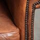 Sheepskin armchair with comfortable seat and finished with decorative nails