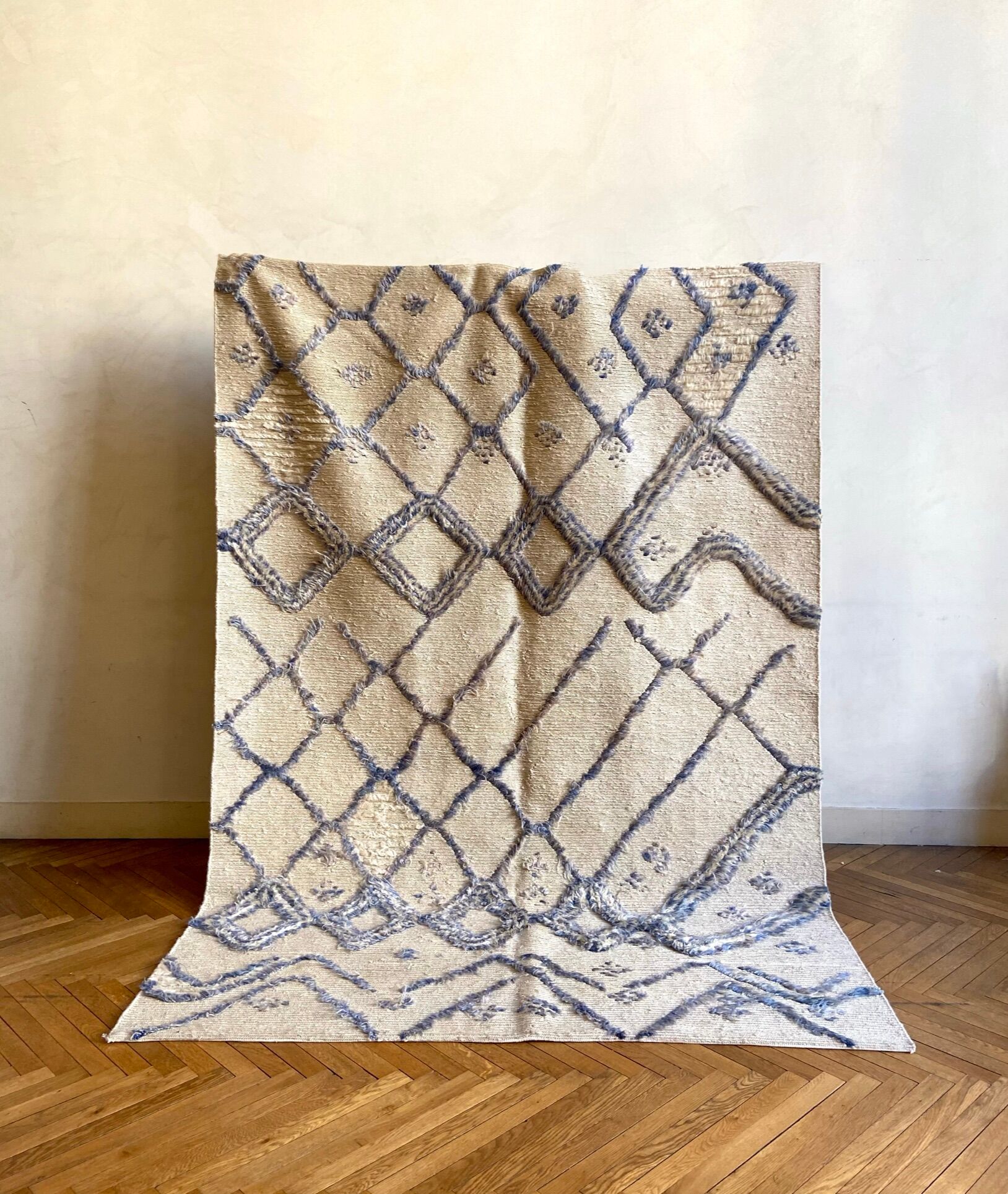 Berber cream carpet with blue patterns