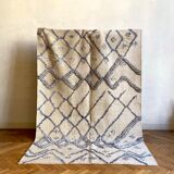 Berber cream carpet with blue patterns