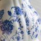 White porcelain milk jug with blue floral designs.