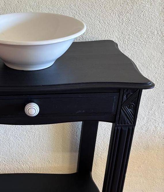 Small Art Deco console reinterpreted – matte black wood with drawer