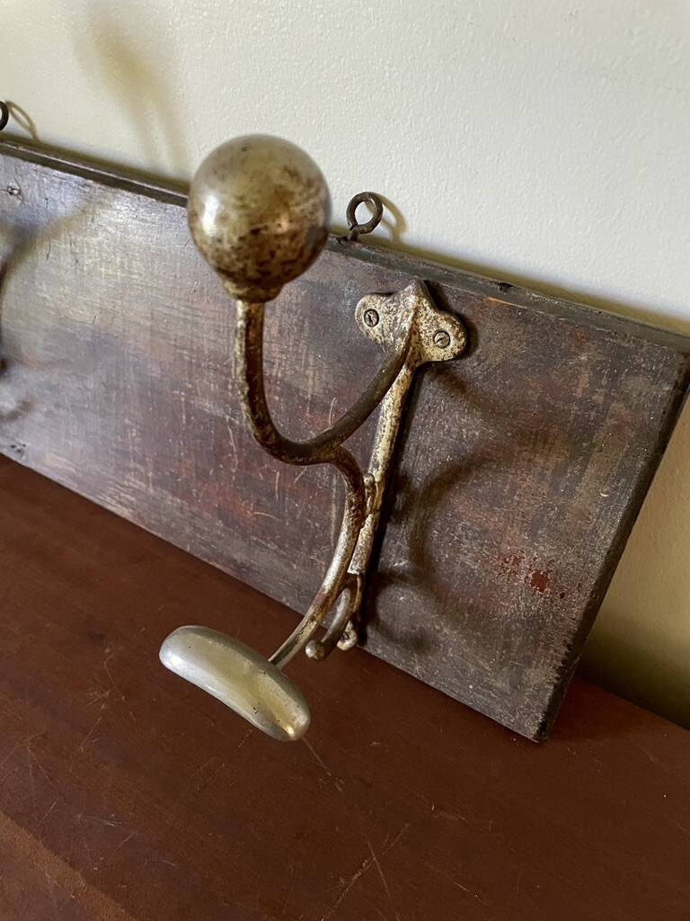Patinated wood and metal coat rack from the 1950s.