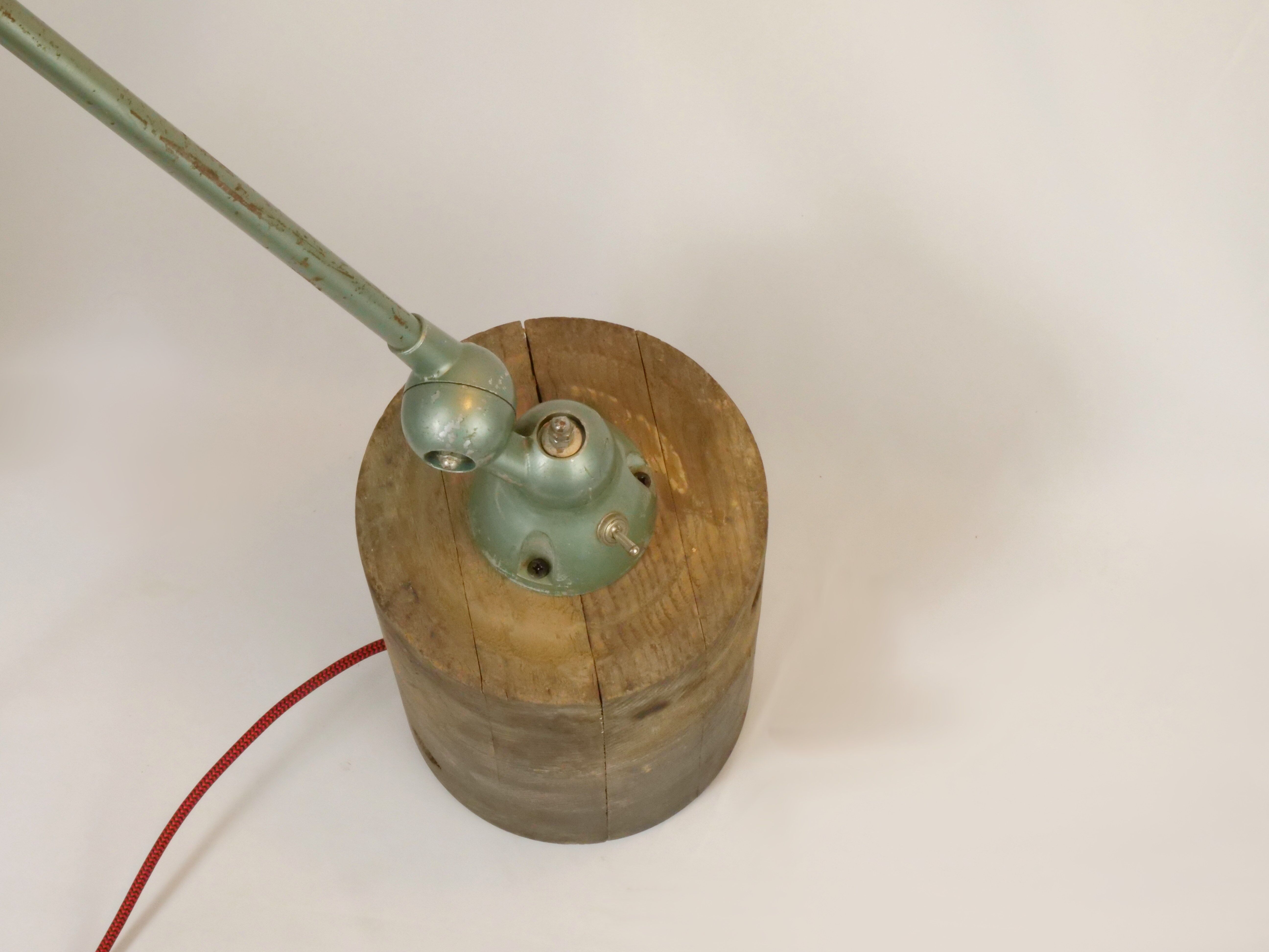 Jielde table lamp with 2 arms on a wooden base.