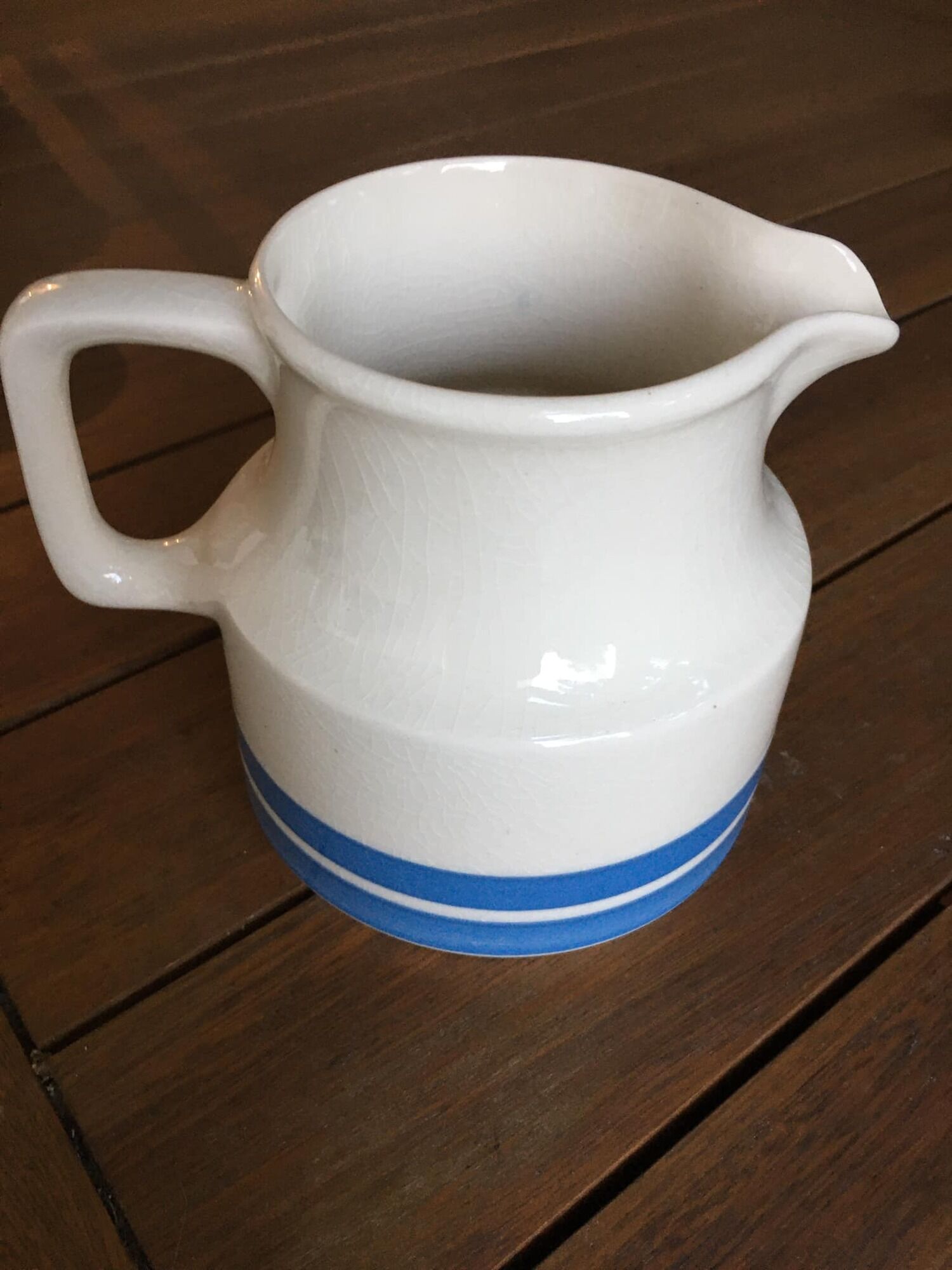 Porcelain pitcher stamped Oxford Ireland. Wide blue stripes on a white background