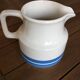 Porcelain pitcher stamped Oxford Ireland. Wide blue stripes on a white background